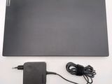 the laptop is sitting on the table with the charger plugged in
