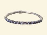 a close up of a silver ring with blue sapphire stones