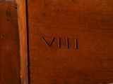 a close up of a wooden table with a clock on it