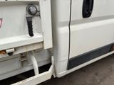 an image of a white van parked in a parking lot
