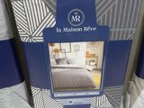 the bedding is blue and white with a pattern on it