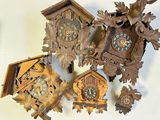a lot of cuckoo clocks that are on the wall