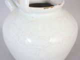 a white vase that has a cracky surface on it