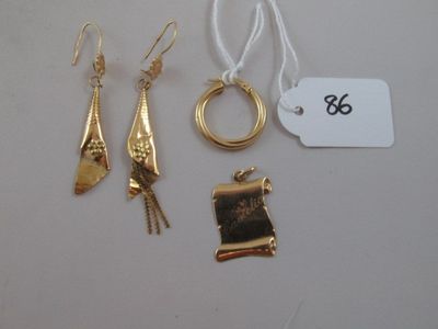 a lot of gold jewelry on a white table