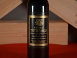 a bottle of wine sitting on a table next to a wooden box