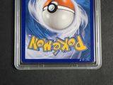 the pokemon trading card is in a plastic holder on a table