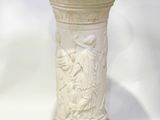 a white vase sitting on a white surface with a white background