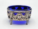 an antique silver and blue glass bowl with lions on it