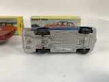 two toy cars sitting next to each other on a table