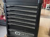 the tool cabinet is sitting on a pallet in the room