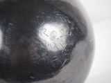 a metal ball with writing on it sitting on a table