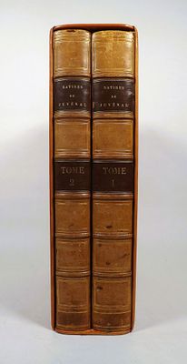 two books are stacked on top of each other on a white surface