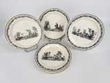 four black and white plates with a picture of people on them