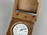 a small wooden box with a clock inside of it