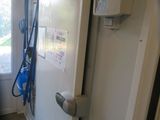 a view of a bathroom through a mirror of a door