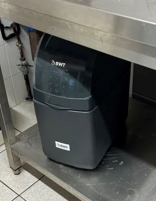 une poubelle posée sous une table en métal