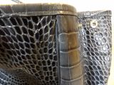 a close up of a black purse with a handle
