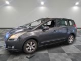 a picture of a gray minivan parked in a garage