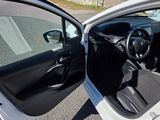 a white car with its door open on the street