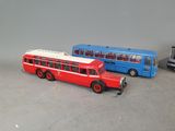 two toy buses sitting next to each other on a table