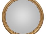 un miroir rond avec un cadre doré sur fond blanc