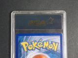 a pokemon card in a plastic case on a table