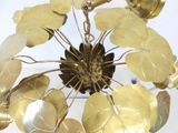 a chandelier made of brass leaves and flowers