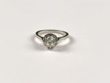 a close up of a diamond ring on a white surface