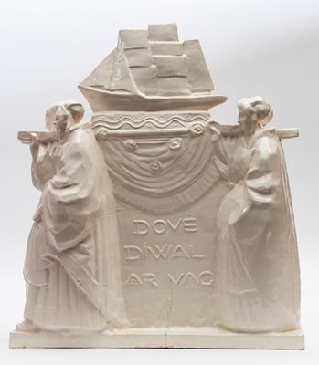 statue of three people standing next to a boat on a white surface