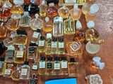 a lot of perfume bottles on a table with a price tag