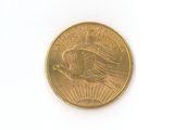 a gold coin with a eagle on it on a white surface