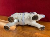 a ceramic animal that is laying down on a table