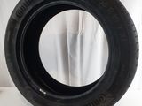 a close up of a tire on a table with a curtain in the background