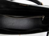 a close up of a black purse with a gold zipper