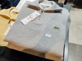 a pile of clothes sitting on a table in a clothing store