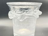 a clear glass vase with a flower design on it