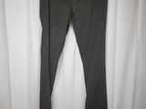 a pair of black pants hanging on a curtain in front of a white curtain