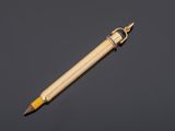 a close up of a pencil with a wooden handle on a black background