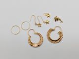 a pair of gold hoop earrings and a pair of star earrings
