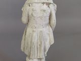 statue of a woman in a white dress and hat with a hat on her head