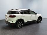the rear end of a white suv parked in a room