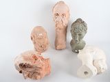 five clay sculptures of different sizes and shapes on a white surface