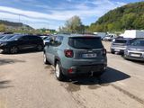 many cars parked in a parking lot with mountains in the background