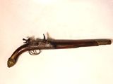 an old gun with a wooden handle on a white surface