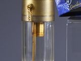 a bottle of perfume next to a box of perfume on a table