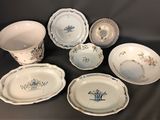 many plates and bowls that are sitting on a table