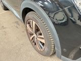 a close up of a car ' s tire on the side of the road