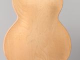 a wooden chair that is sitting on a clear stand