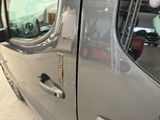 a close up of a door handle on a silver truck