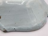 a white plate with a blue design on it